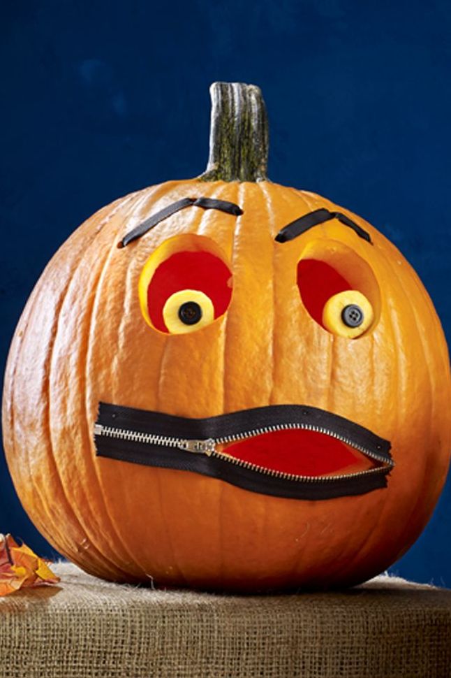 Orange pumpkin adorned with exaggerated human-like makeup, creating a playful and whimsical effect